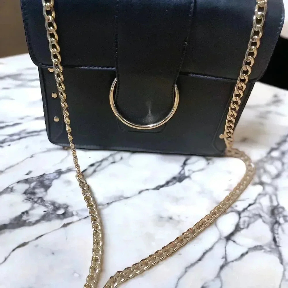 BLACK STUDDED LEATHER CROSSBODY WITH GOLD CHAIN STRAP AND GOLD BUCKLE CLOSURE
